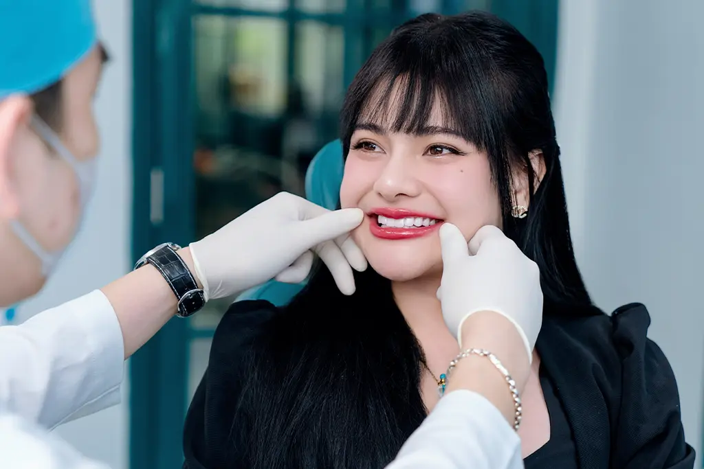 Dentist examining patient's smile and taking impressions for custom dental veneers