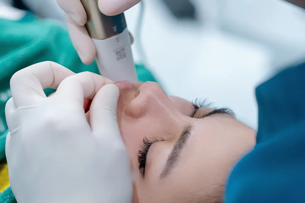Dentist using an intraoral scanner on a patient for custom dental veneers