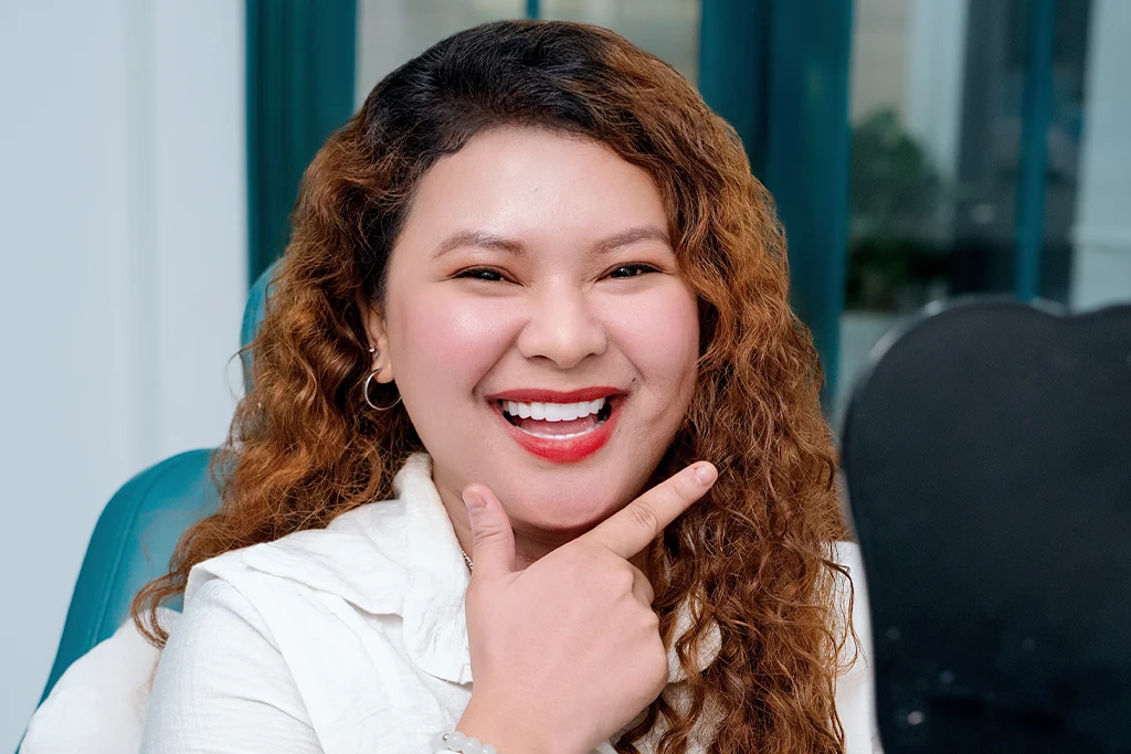 Happy patient showing a natural and confident smile after getting dental implants